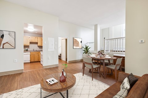 an open living room with a dining room table and a kitchen